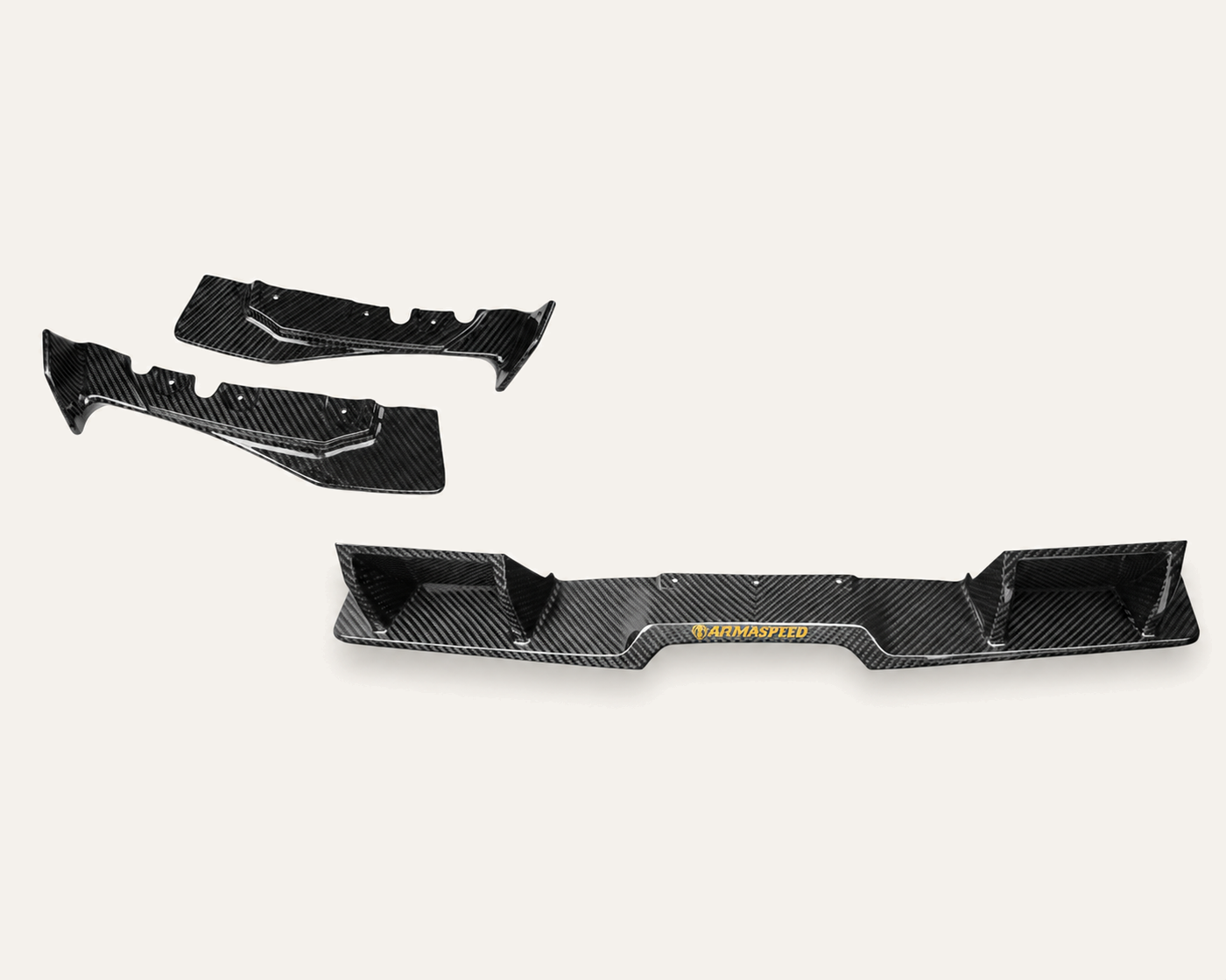 First carbon fiber samples of three rear diffuser pieces, in studio lighting.