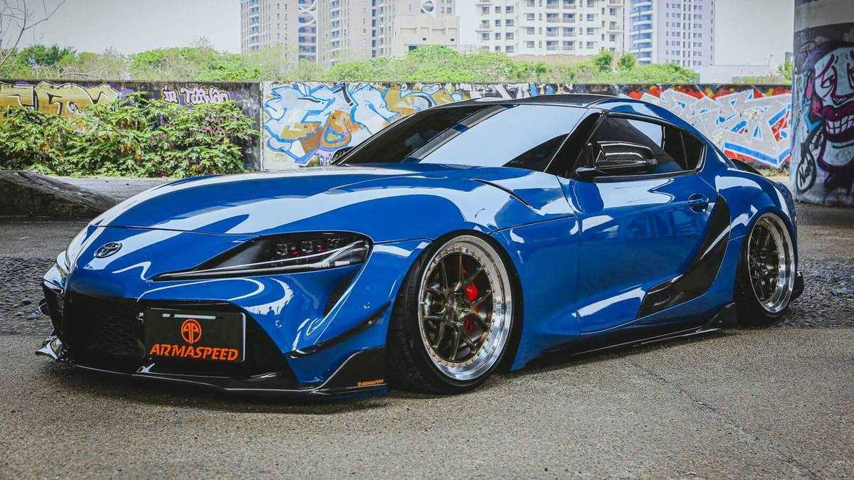 Toyota Supra A90 with the ARMASPEED carbon kit, side view.