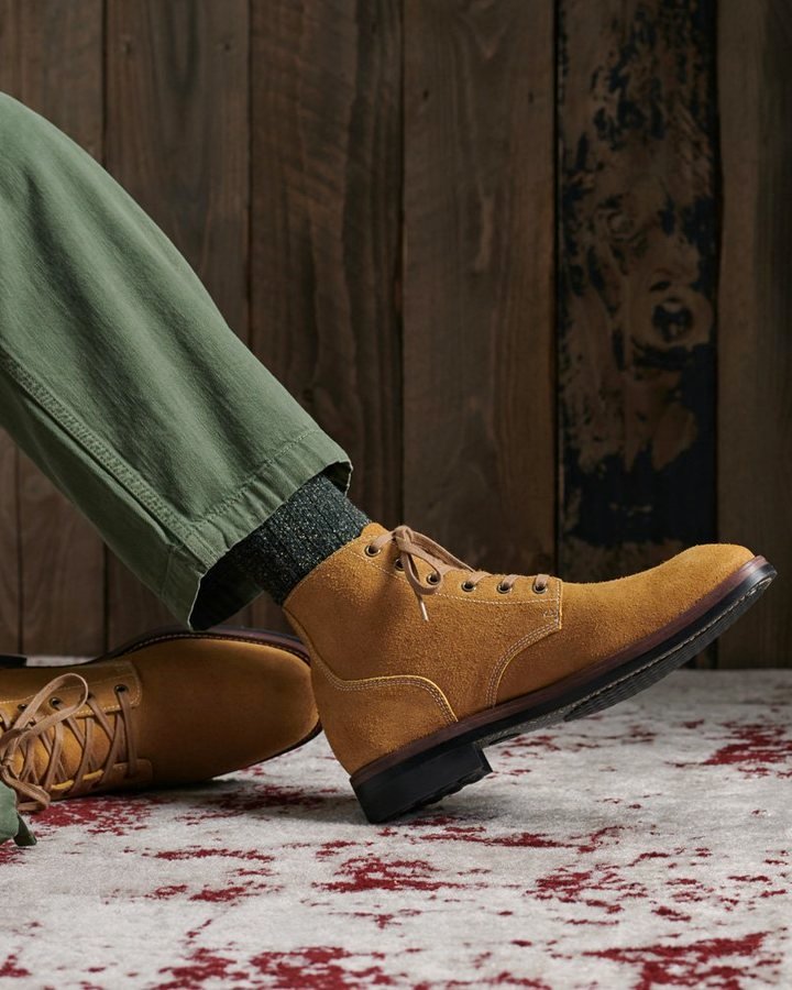 Officer Boots in honey-suede on red-spattered concrete, paired with green chinos.
