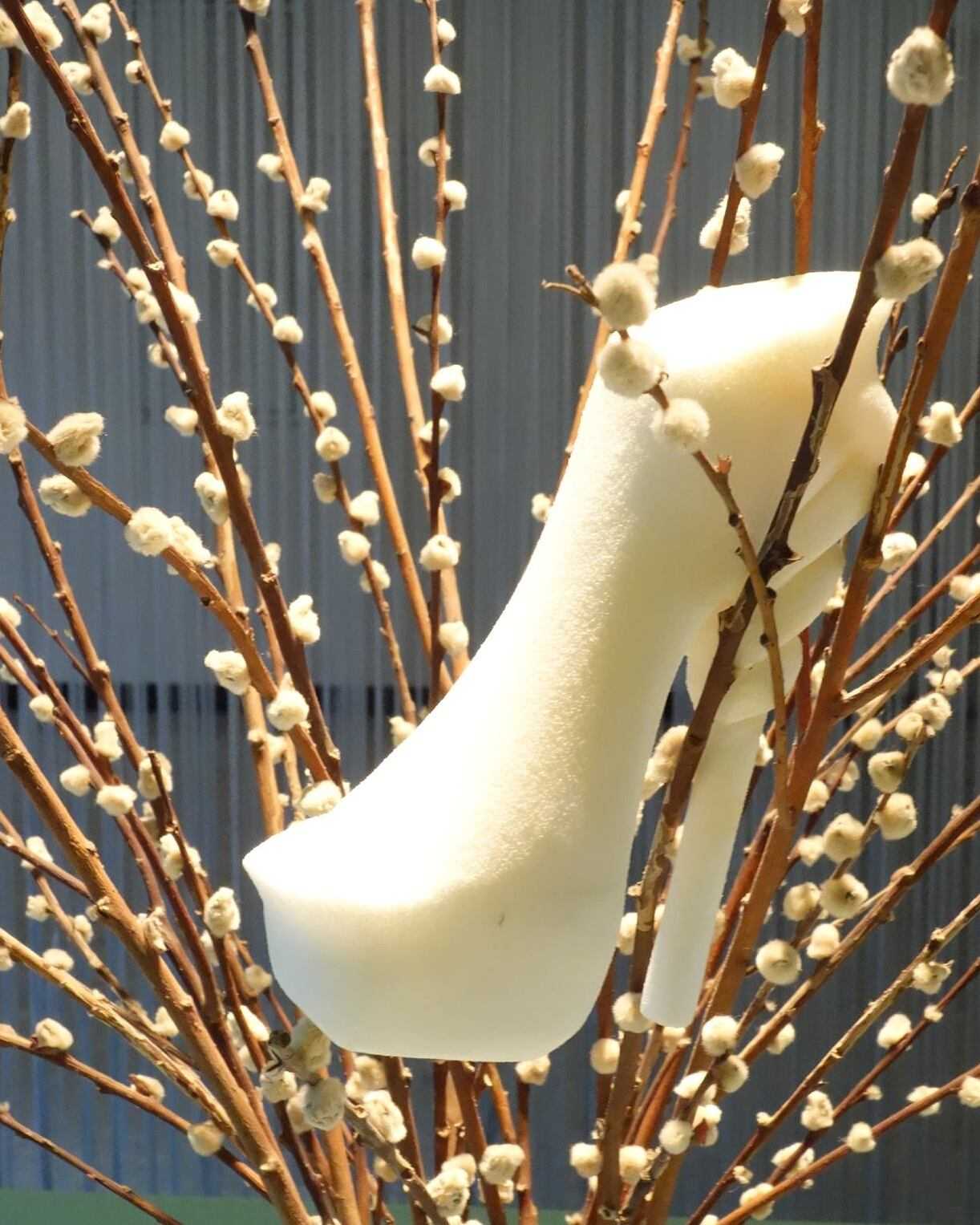 The same cream-buff PU study model displayed among dried catkin branches, photographed at the school library after the model was finished.