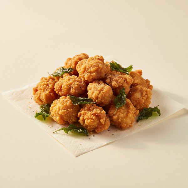Popcorn chicken — golden fried bite-sized pieces with basil.